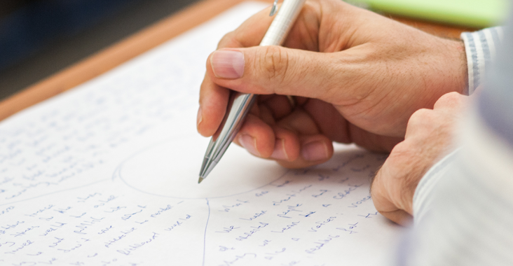 An image of someone writing with pen on paper